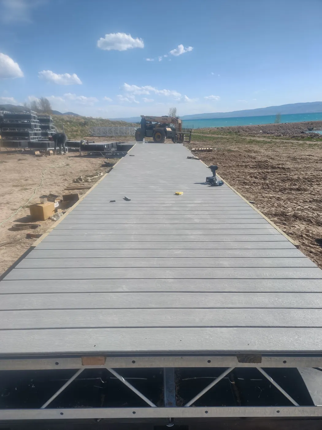 Composite decking going onto a steel truss dock section on shore before it goes in