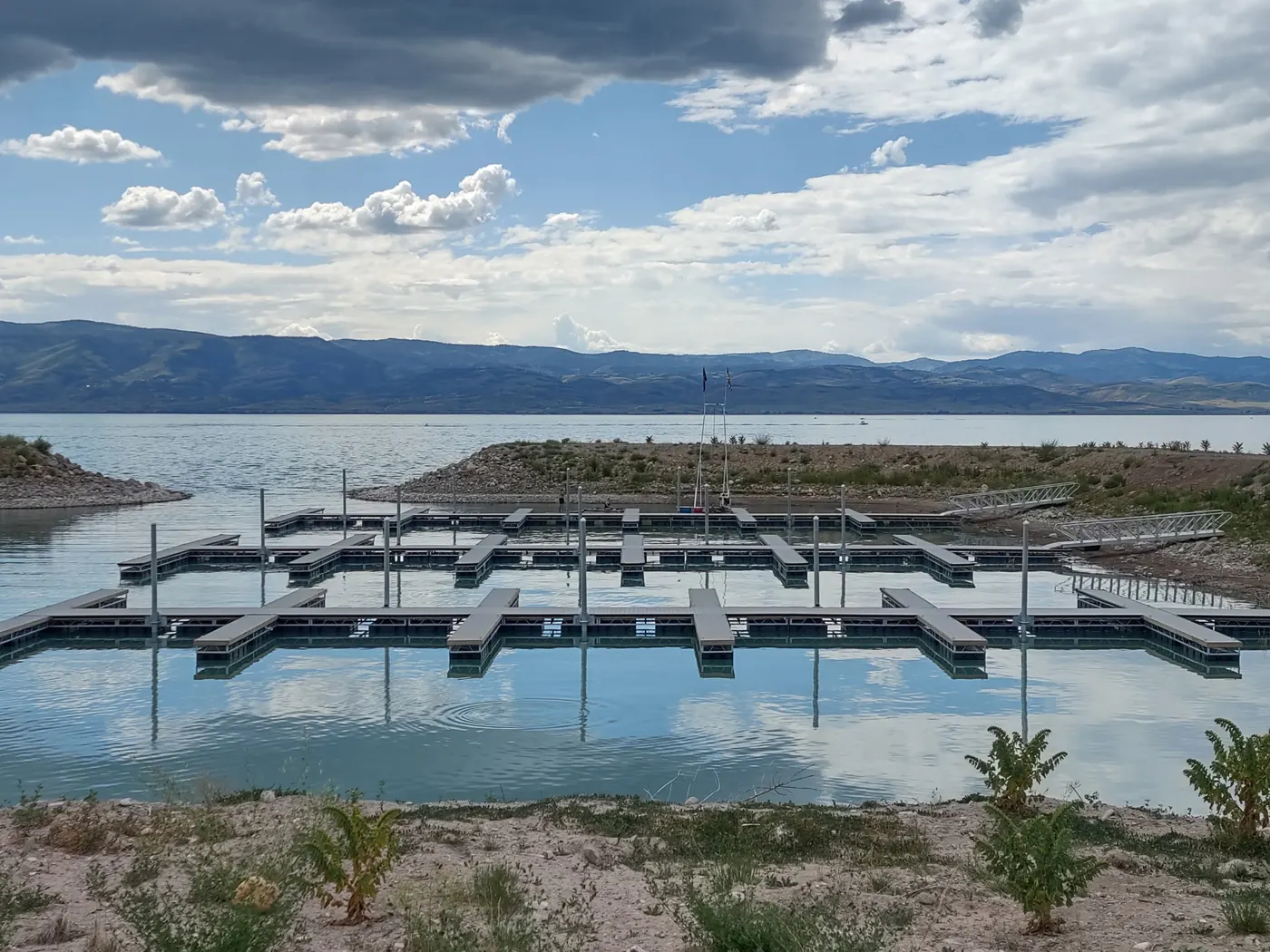 Finished marina of floating docks and guide piles on Bear Lake, mountains across the water