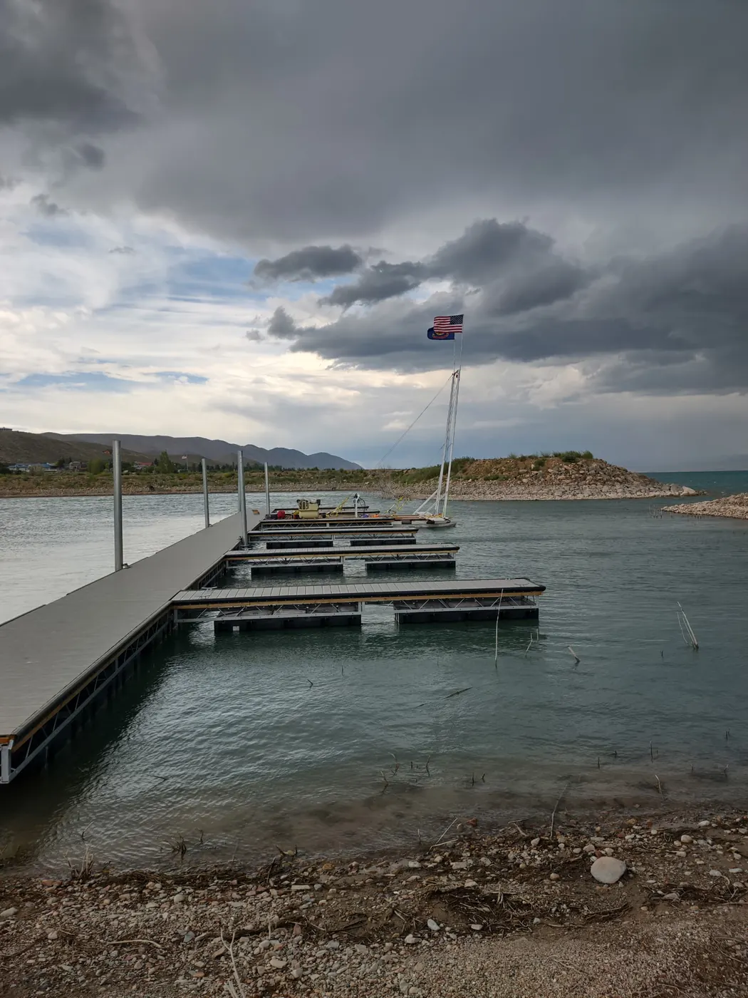 Main walk and finger slips of the new marina under a stormy sky, flags flying at the entrance