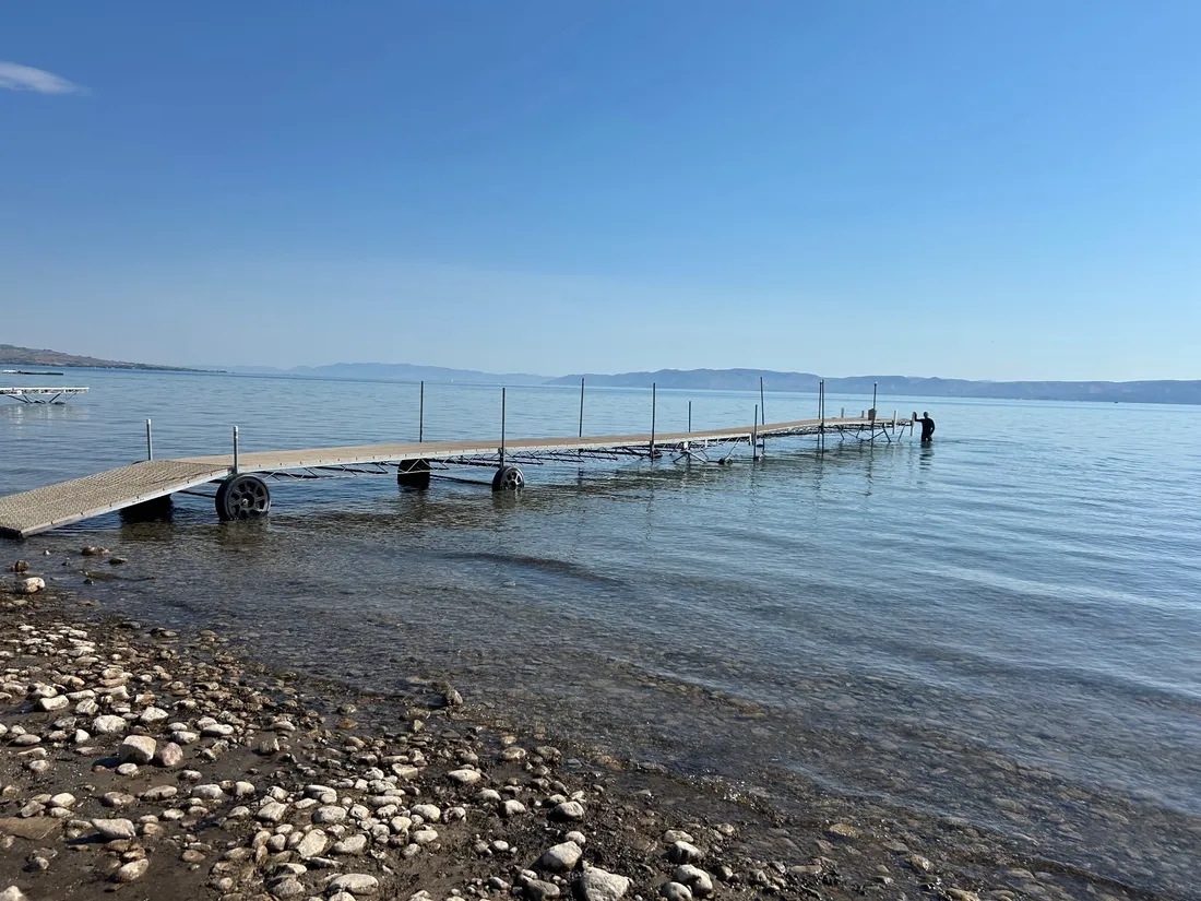 Roll in dock with aluminum frame and wheels set in clear, calm water on Bear Lake